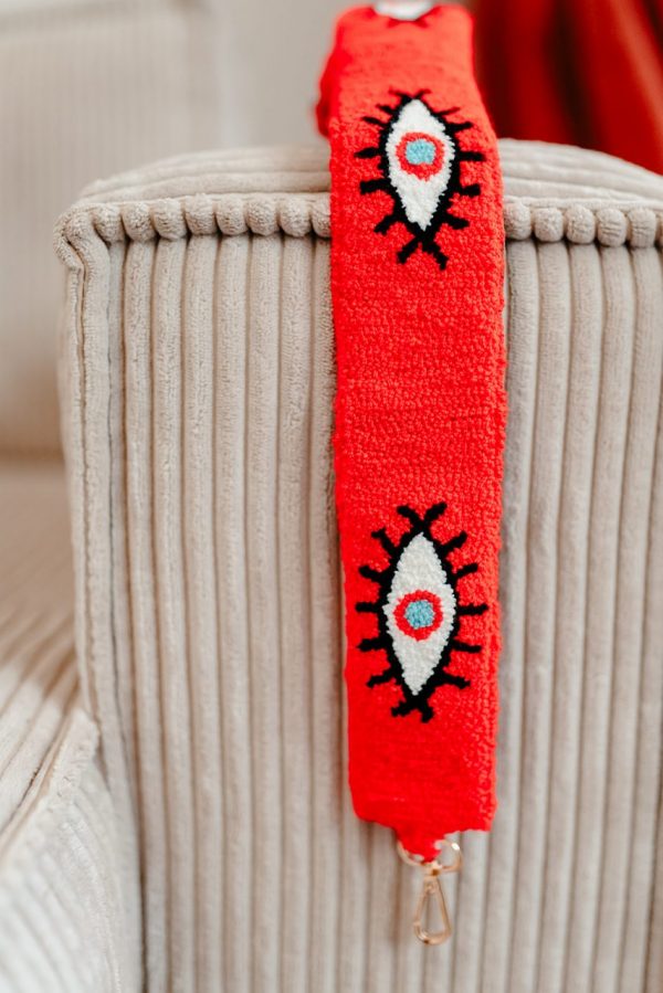 Bandoulière couleur rouge flashy brodée à la main avec un motif oeil